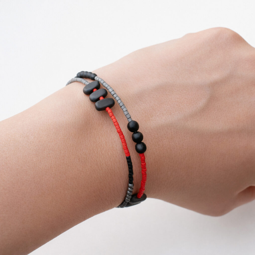 Black red and grey beaded bracelet worn on wrist