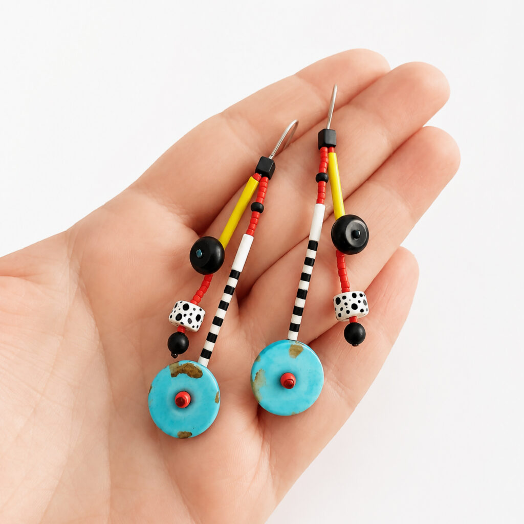 Turquoise beaded earrings shown in hand for scale