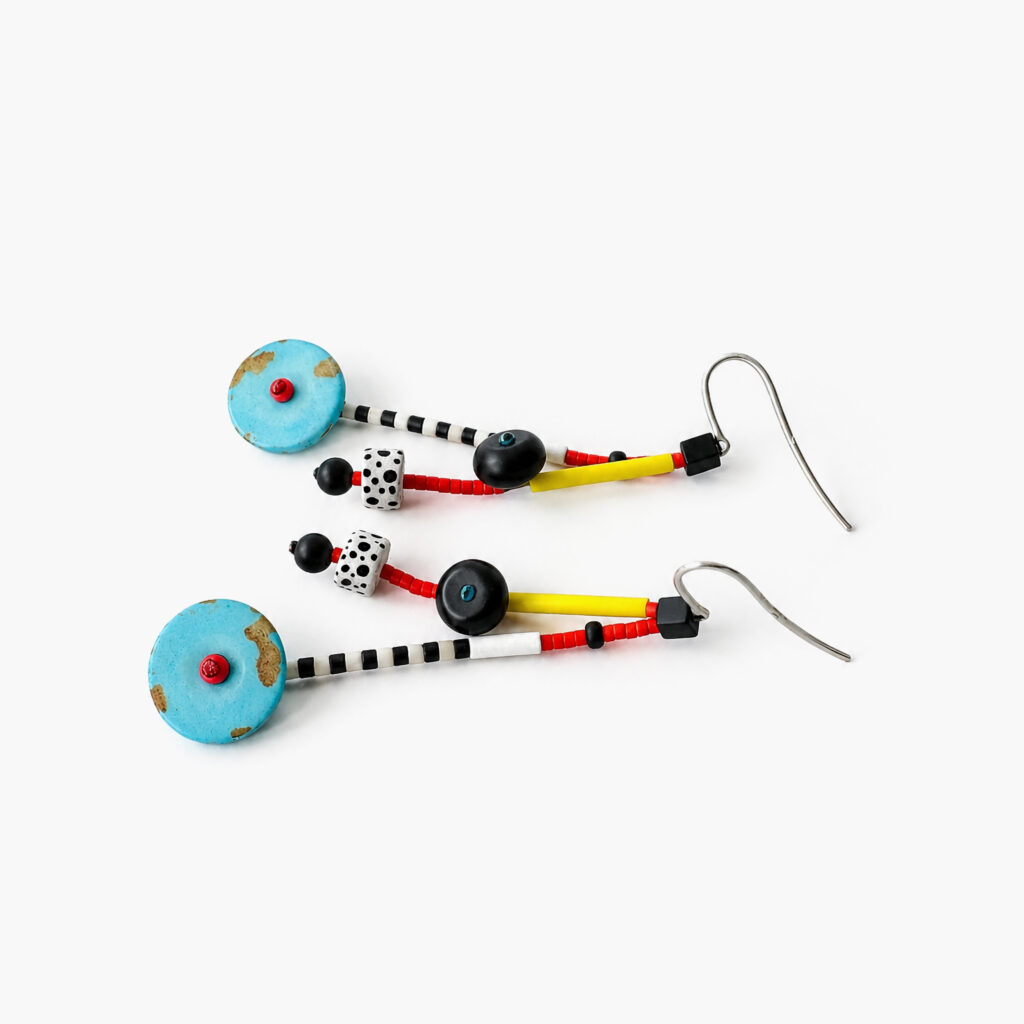 Angled view of Turquoise beaded earrings showing circular, striped and polka-dot beads