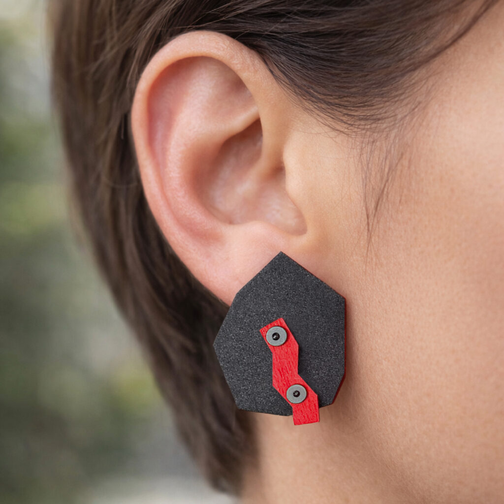 Black red industrial geometric wooden earring worn on the ear