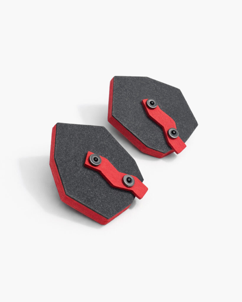 Black red geometric wooden earrings with angular forms and exposed hardware on a white background