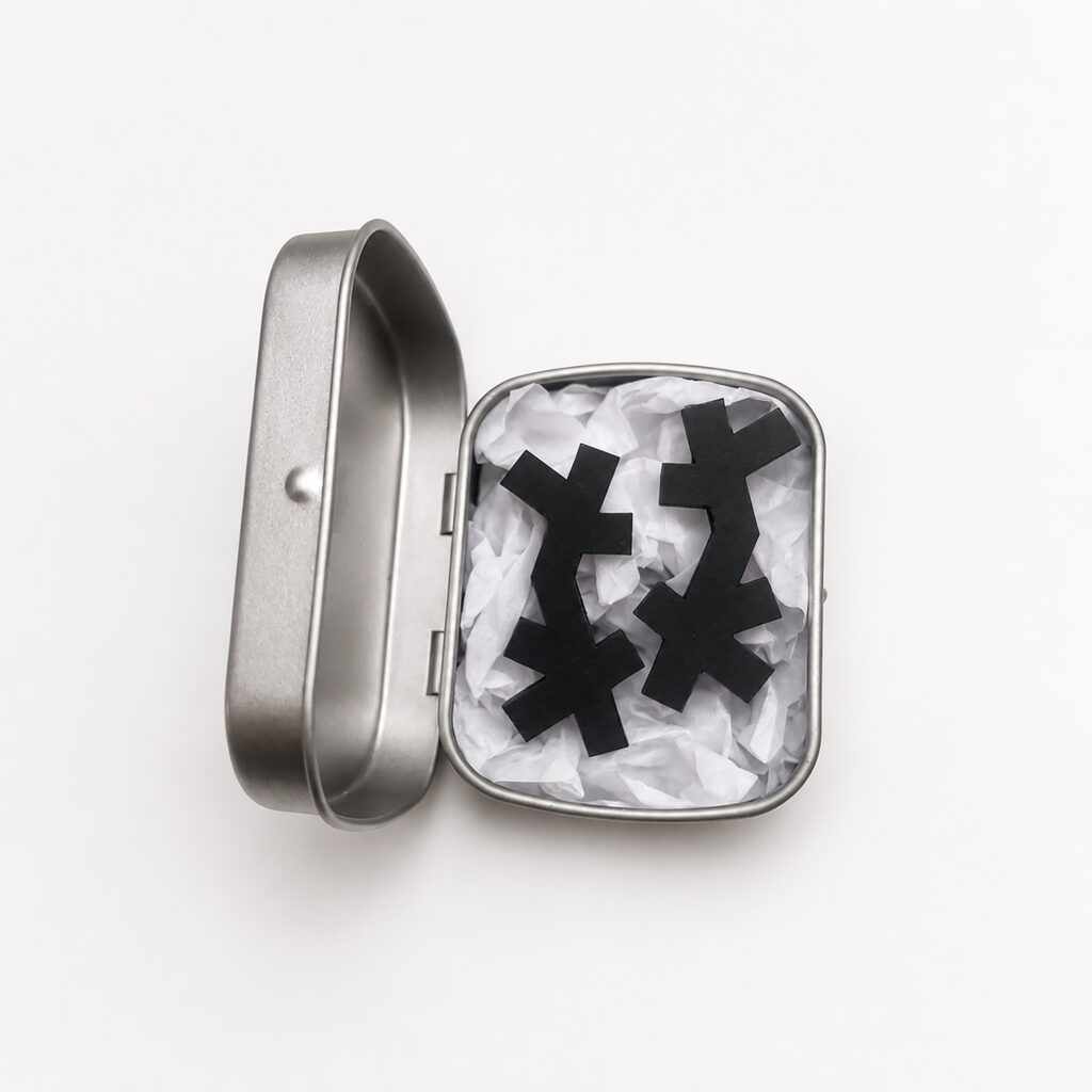 Black geometric wooden earrings displayed in a metal gift box