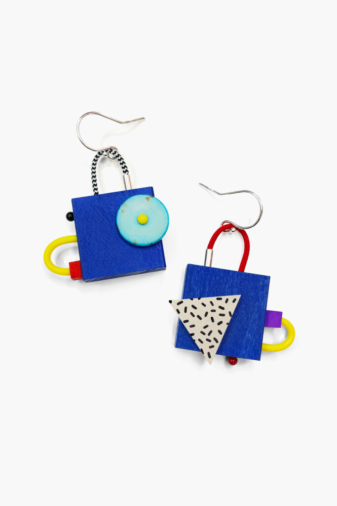 Colorful mismatched geometric wooden earrings with blue squares and turquoise circular details