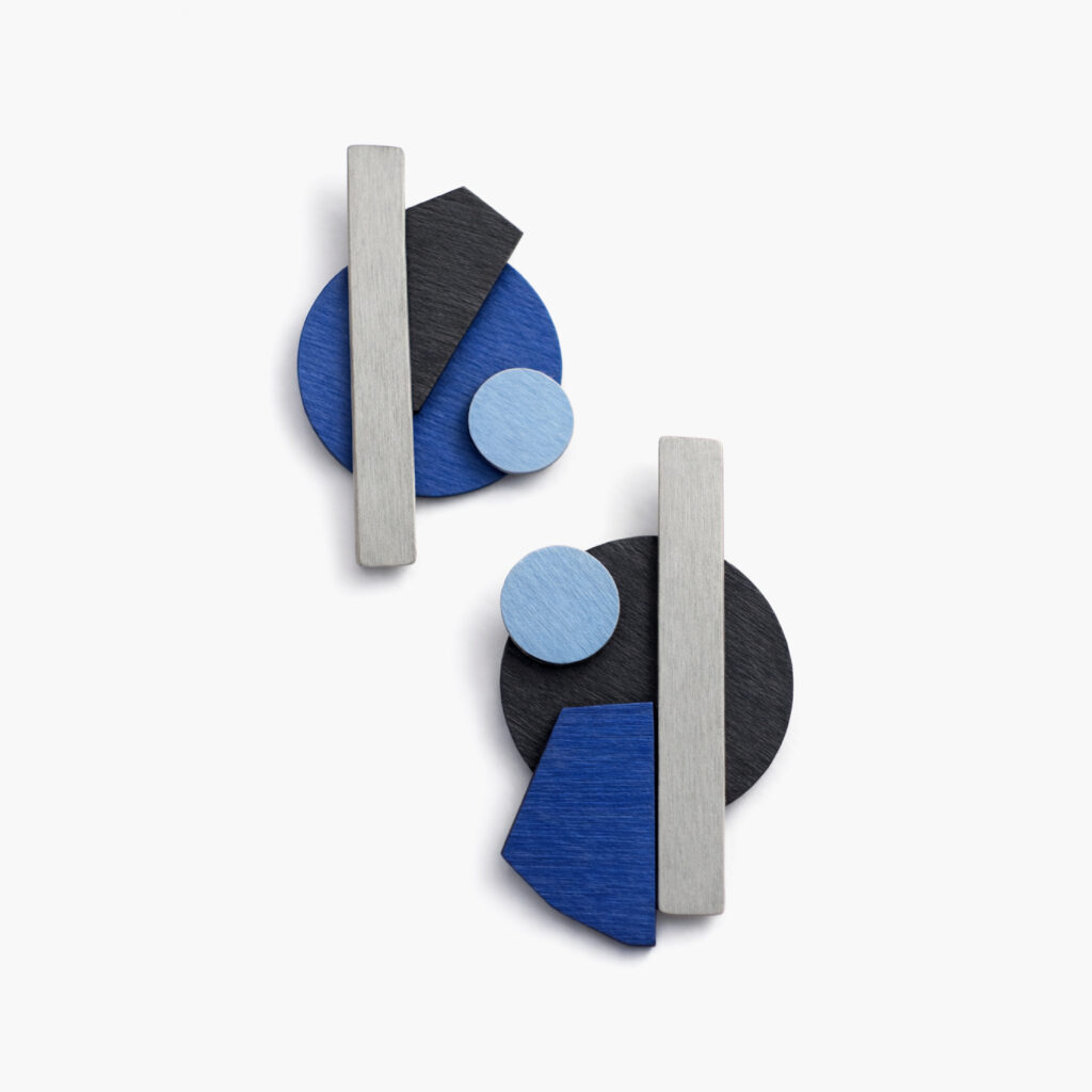 Blue and black mismatched geometric wooden earrings with grey bars and light blue circles