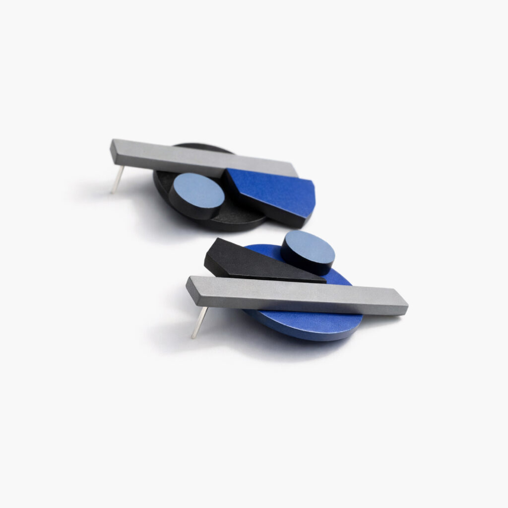 Blue black and grey wooden earrings showing layered construction – side view
