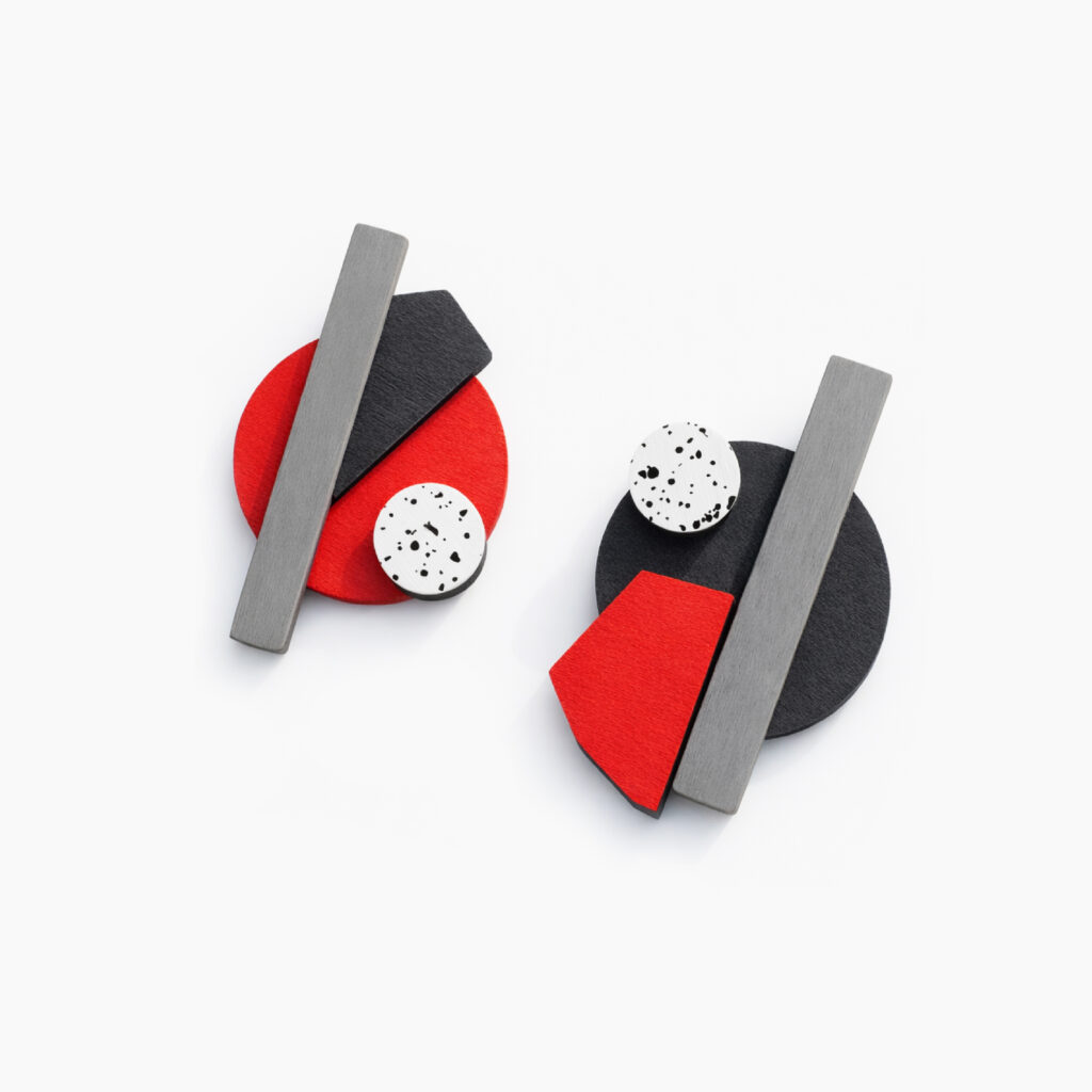 Abstract red and black wooden earrings with white speckled circular accents
