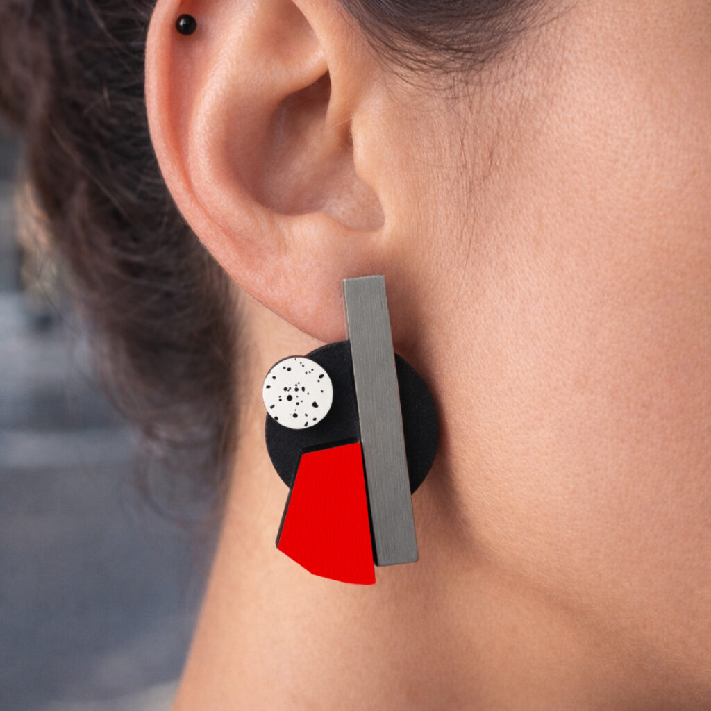 Red black and grey geometric statement earring worn on ear