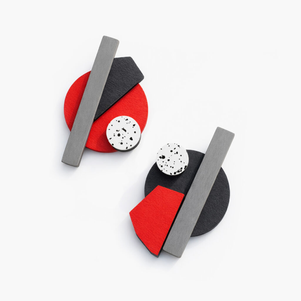 Asymmetrical statement earrings with red and black shapes and silver-grey bars