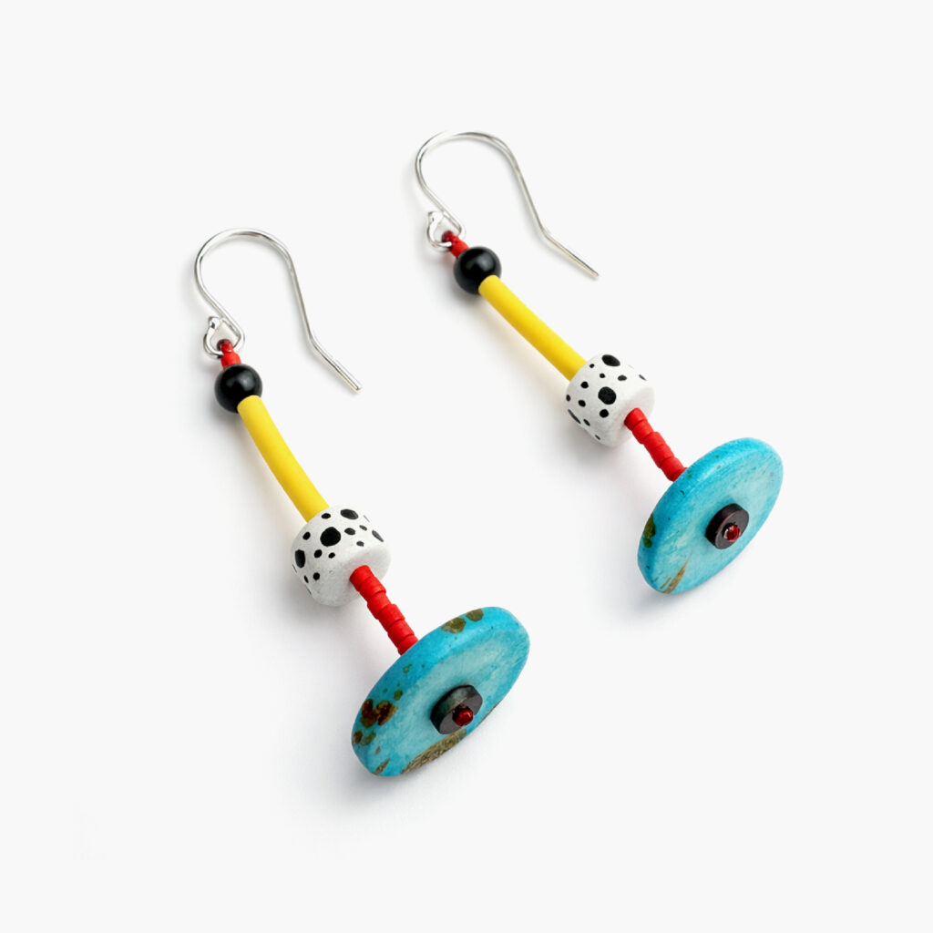Pair of colorful geometric earrings with turquoise wooden discs and yellow details – angled view