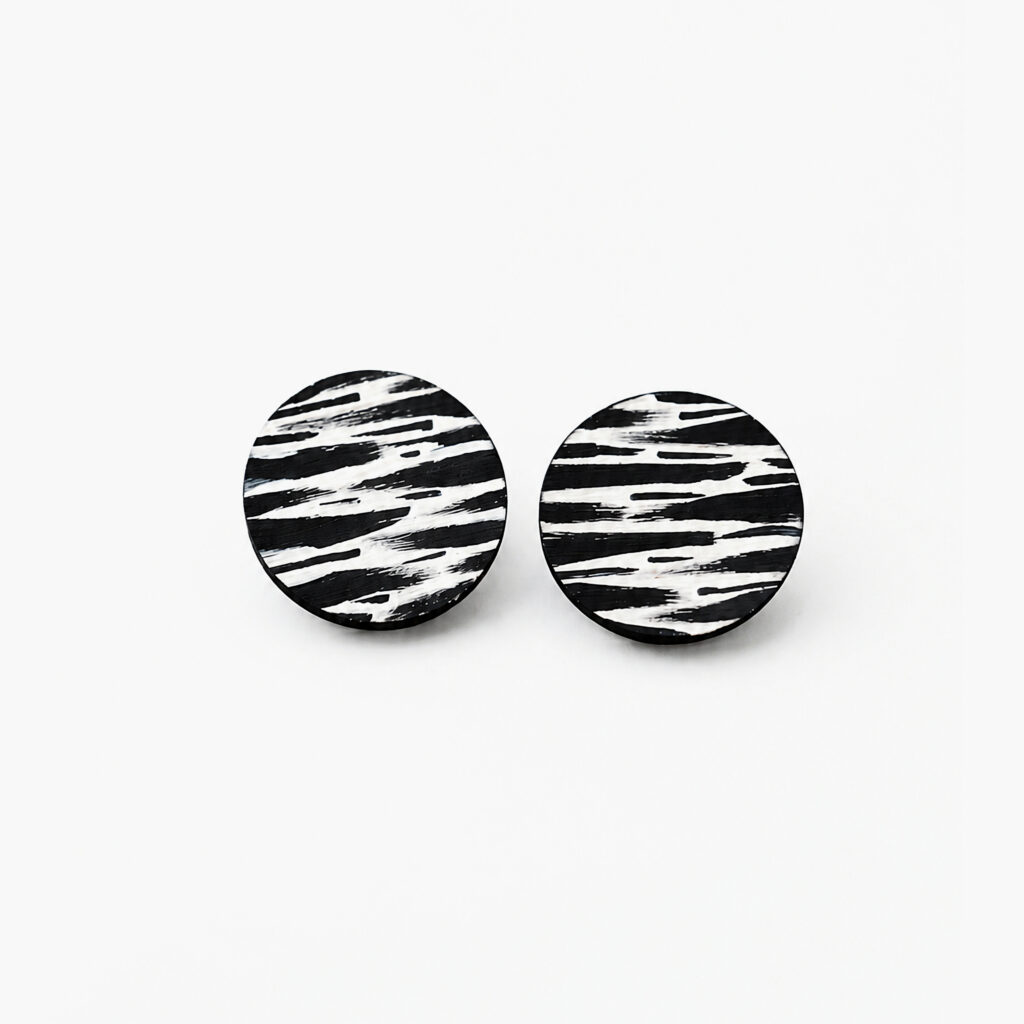 Pair of black and white zebra pattern geometric stud earrings on white background