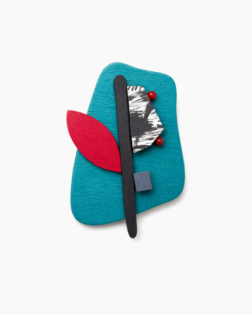 Petrol abstract brooch with red and black geometric details